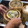 Dim sum steamer baskets fly off the food carts.
