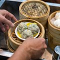 Dim sum steamer baskets fly off the food carts.