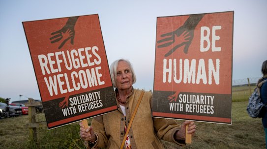 A woman protests against the Rwanda deportation flight at Boscombe Down Air Base in Wiltshire, England this week.