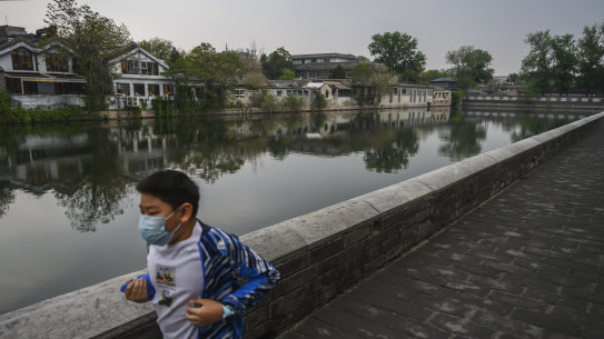 A boy gets some exercise along the moat outside Beijing's Forbidden City. China has hit back at its critics.