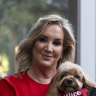 Gina Edwards and Oscar the cavoodle after she won her defamation case against Nine.