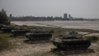 Tanks used by the Taiwan military are seen on display for tourists at a beach in Kinmen, Taiwan. Kinmen is so close to China that the deep-water port of Xiamen, one of China’s biggest, lies less than three miles away across the water.