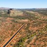 What is the name of the highway that runs north-south through the middle of Australia?