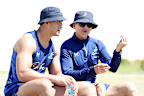 Les Kiss speaks to Joseph-Aukuso Suaalii during a Wallabies training session.