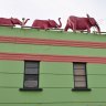 Three pink elephant stride atop the colourful Windsor Castle Hotel.
