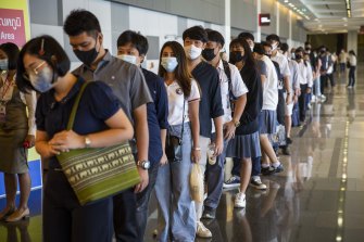 Thai job seekers wait in line at the Job Expo in Bangkok on Monday.