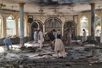 People view damage inside the mosque following the bombing.