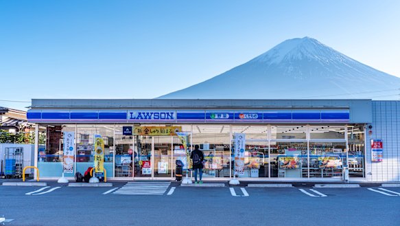 A Lawson convenience store with Mount Fuji in the background. 