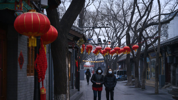 Chinese women walk in a usually busy shopping and tourist area during the Chinese New Year holiday in Beijing, China. 