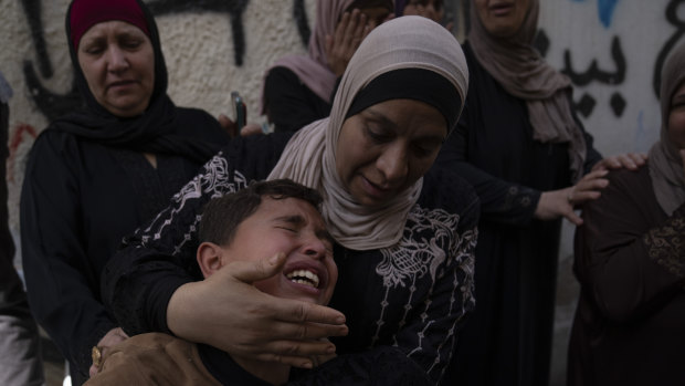 A boy cries while mourners take the last look at the body of Ramzi Zabarah, 35, at the family house, during his funeral in the West Bank near Nablus.
