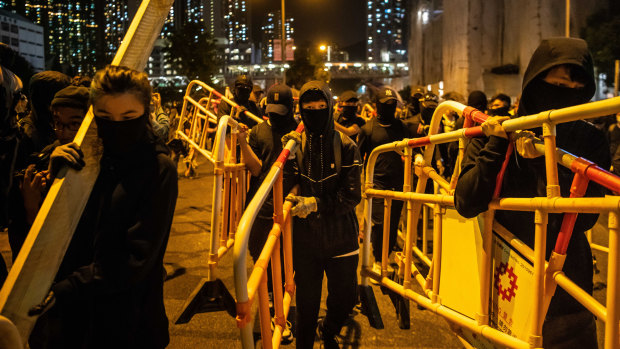 Protesters set up barricades in Tseung Kwan O, Hong Kong, after a ceremony paying tribute to (Alex) Chow Tsz-lok on Friday night.