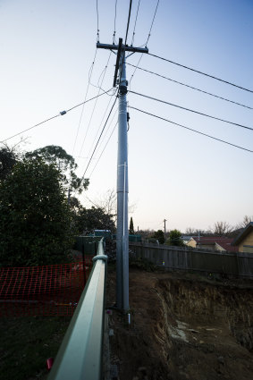 The power pole that became unstable after excavation commenced. A geotechnical assessment  has since found no safety issues although the concrete block remains.