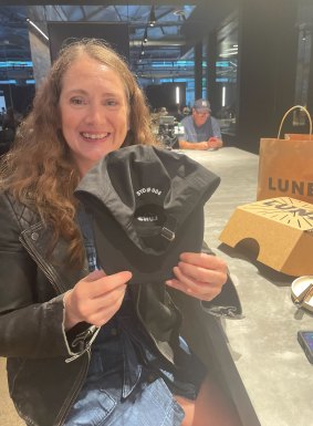 Stephanie Evans-Davies poses with the commemorative cap marking her as the sixth customer to enter Lune’s Sydney store.