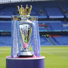 The English Premier League trophy sits in an empty stadium.