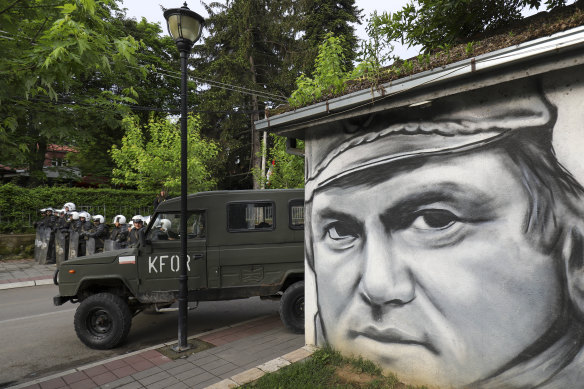 Polish soldiers, part of an international peacekeeping mission, in the town of Zvecan, Kosovo, where street art celebrates the former Bosnian Serb general Ratko Mladic, who in 2017 was found guilty in the Hague of committing war crimes, crimes against humanity and genocide. The International Criminal Tribunal for the former Yugoslavia found Mladic was ultimately responsible for the siege of Sarajevo and the Srebrenica massacre.