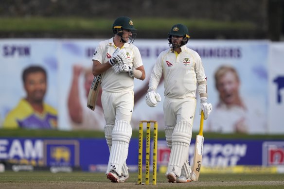 Pat Cummins and Nathan Lyon leave the ground when play is abandoned early because of bad light.