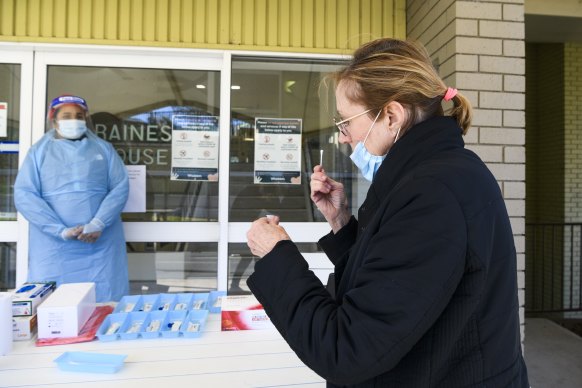 A staff member at the Whiddon Easton Park aged care facility in Sydney undergoes a rapid test during a trial. 