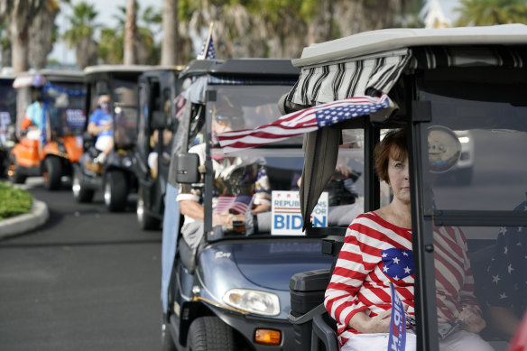 A convoy of about 300 golf carts supporting Democratic presidential candidate Joe Biden heads to an early-voting post in The Villages.