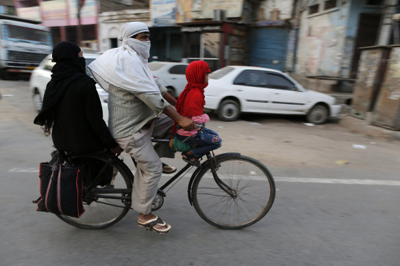 A Muslim family cycles home in Prayagraj, India.