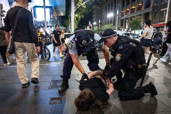 Protesters and police clash near Sydney’s Town Hall last night. 