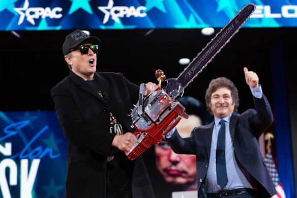 Elon Musk revels in the chainsaw gift he received from Argentina’s President Javier Milei on stage at the Conservative Political Action Conference on February 20.