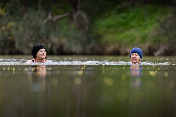 Meg Elkins (left) and Holly Jones swim in the Yarra at Deep Rock.