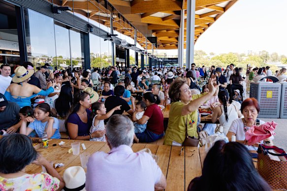 Visitors pack outdoor seating areas the new fish market overlooking Blackwattle Bay.