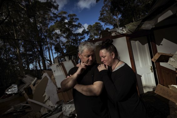 Lee and Nat Guest stand in the ruins of their home in Kalorama. 