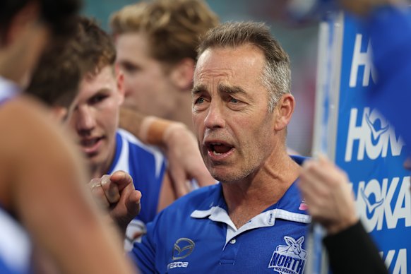 North Melbourne coach Alastair Clarkson speaks to his players.