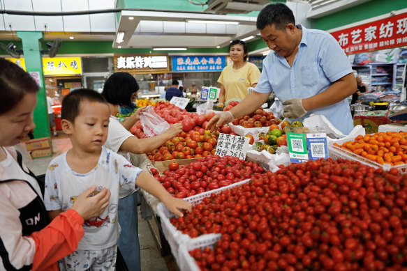 Customers at a produce market in Beijing.
