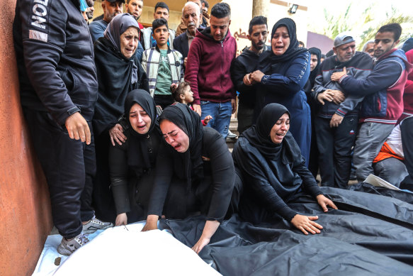 People mourn as they collect the bodies of Palestinians killed in an airstrike on in Khan Yunis, southern Gaza on Wednesday.