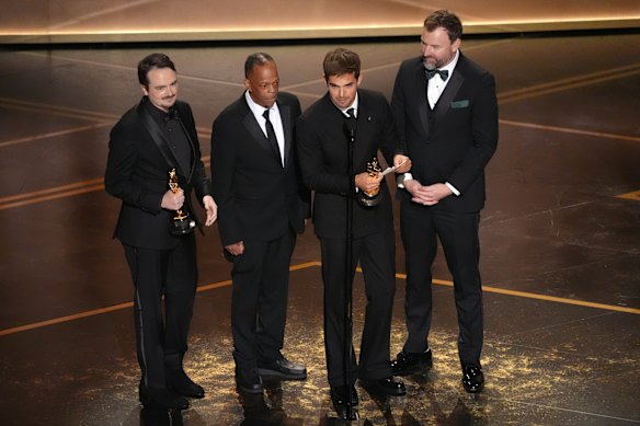 David Breschel, Mike Yung, Sam A. Davis and Jack Piatt accept the award for live action short film for The Singers.