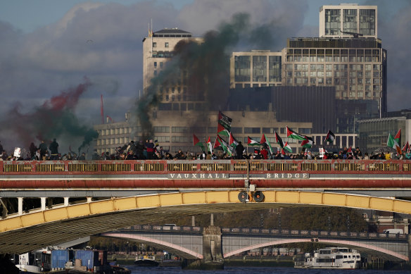 Protesters wave flags and hold flares during a pro-Palestinian protest in London on Saturday.