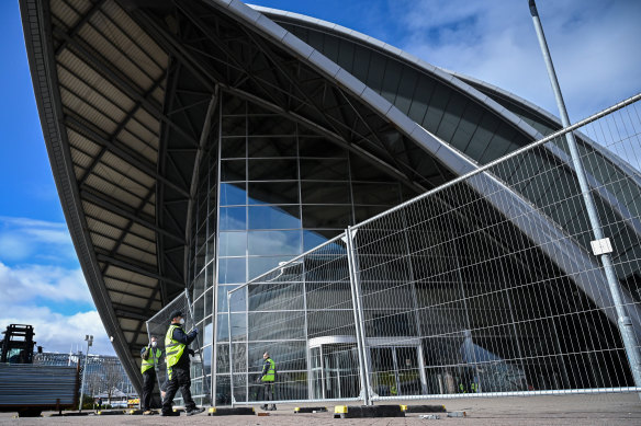 Workmen erect fencing around Glasgow's Scottish Exhibition & Conference Centre as it is turned into a field hospital.