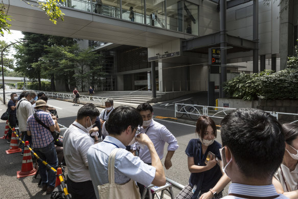 Journalists wait outside the Keio University Hospital for news of Japanese PM Shinzo Abe.