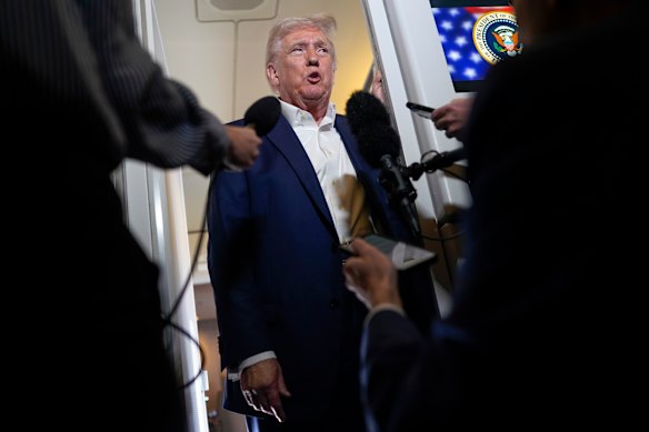 US President Donald Trump speaking to reporters on board Air Force One on Friday.