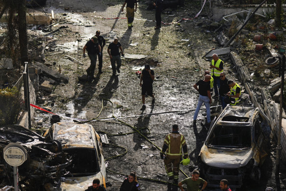 Israeli security forces examine the site hit by a rocket fired from Lebanon.