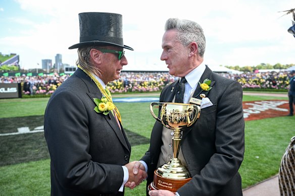 Outgoing VRC chair Neil Wilson (right) with the Melbourne Cup.