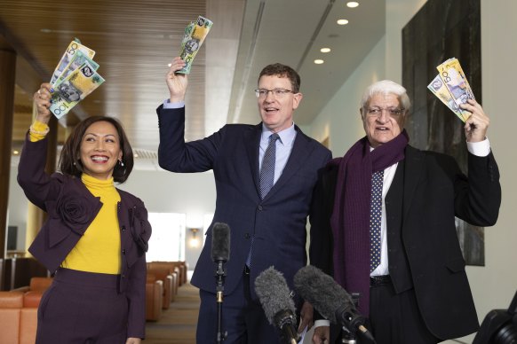 Gee (centre), with fellow independent MPs Dai Le and Bob Katter, poses with fake money after addressing the media at a press conference.