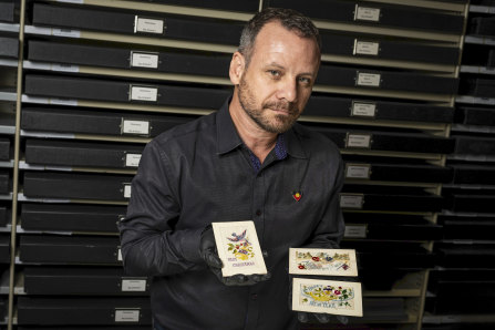 Australian War Memorial curator Garth O’Connell with the 1916 postcards linked to Indigenous WWI soldier Charlie Runga.