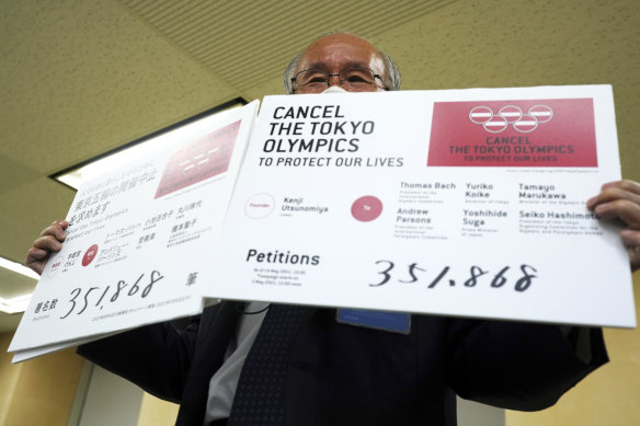 Lawyer Kenji Utsunomiya, a representative of an anti-Olympics group, displays the number of signatures on a petition to cancel the Tokyo Olympics and Paralympics, On Friday.