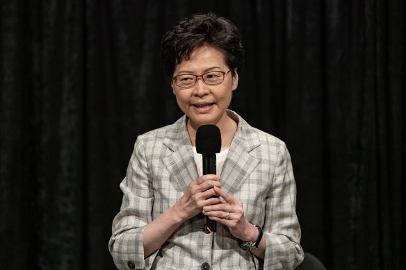 Hong Kong Chief Executive Carrie Lam addresses a packed stadium during her community dialogue session.