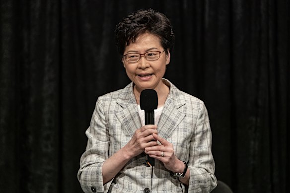 Hong Kong Chief Executive Carrie Lam addresses a packed stadium during her community dialogue session.