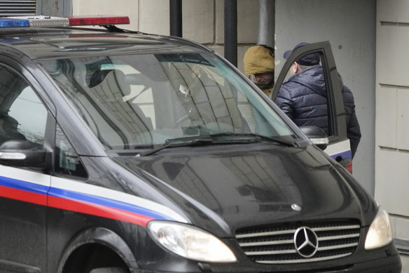 Wall Street Journal reporter Evan Gershkovich is escorted by officers from the Lefortovsky court to a bus in Moscow.