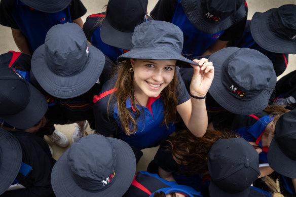 Eva Urtone dons a hat after Matthew Flinders Girls Secondary College implemented a no hat, no play policy for high school students.