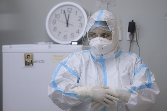 A member of the medical staff adjusts her gloves at the COVID-19 ICU unit of the Marius Nasta National Pneumology Institute in Bucharest, Romania.