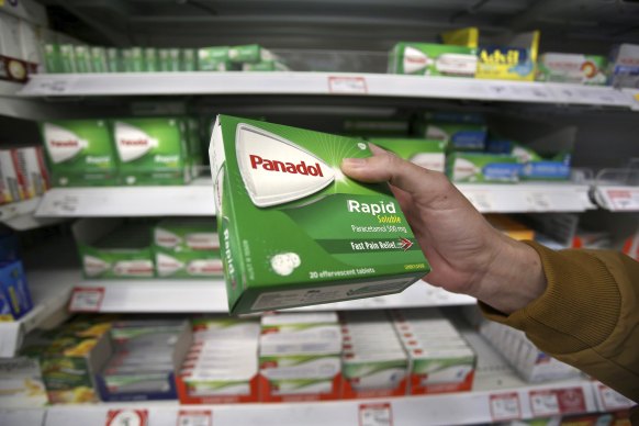 A customer inspecting a box of Paracetamol tablets. 