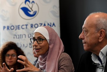 Fellowship recipient Dr Khadra Salami flanked by Noor and Saeed Maasarwe. 