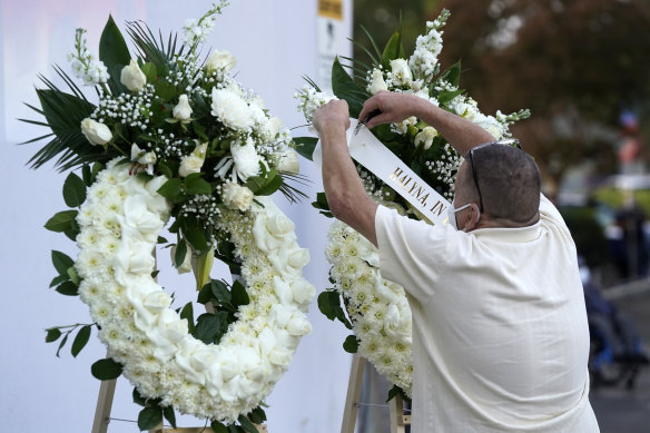 A man puts up a wreath before a candlelight vigil for the late cinematographer Halyna Hutchins on Sunday.