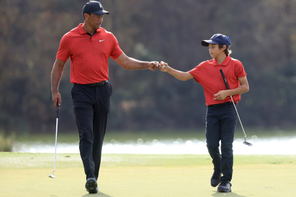Tiger and Charlie Woods celebrate a birdie.